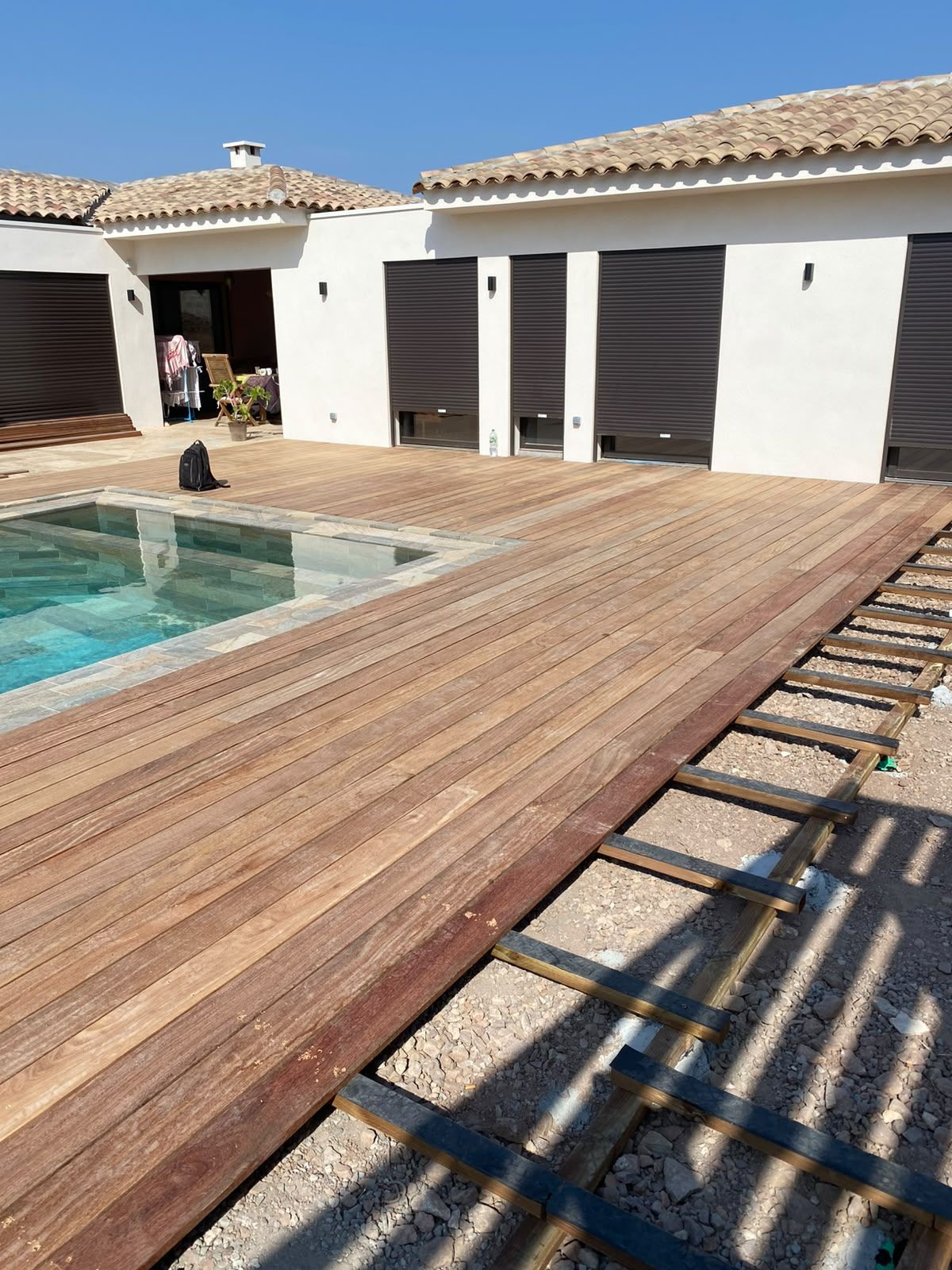 Terrasse en bois exotique terminée autour d'une piscine